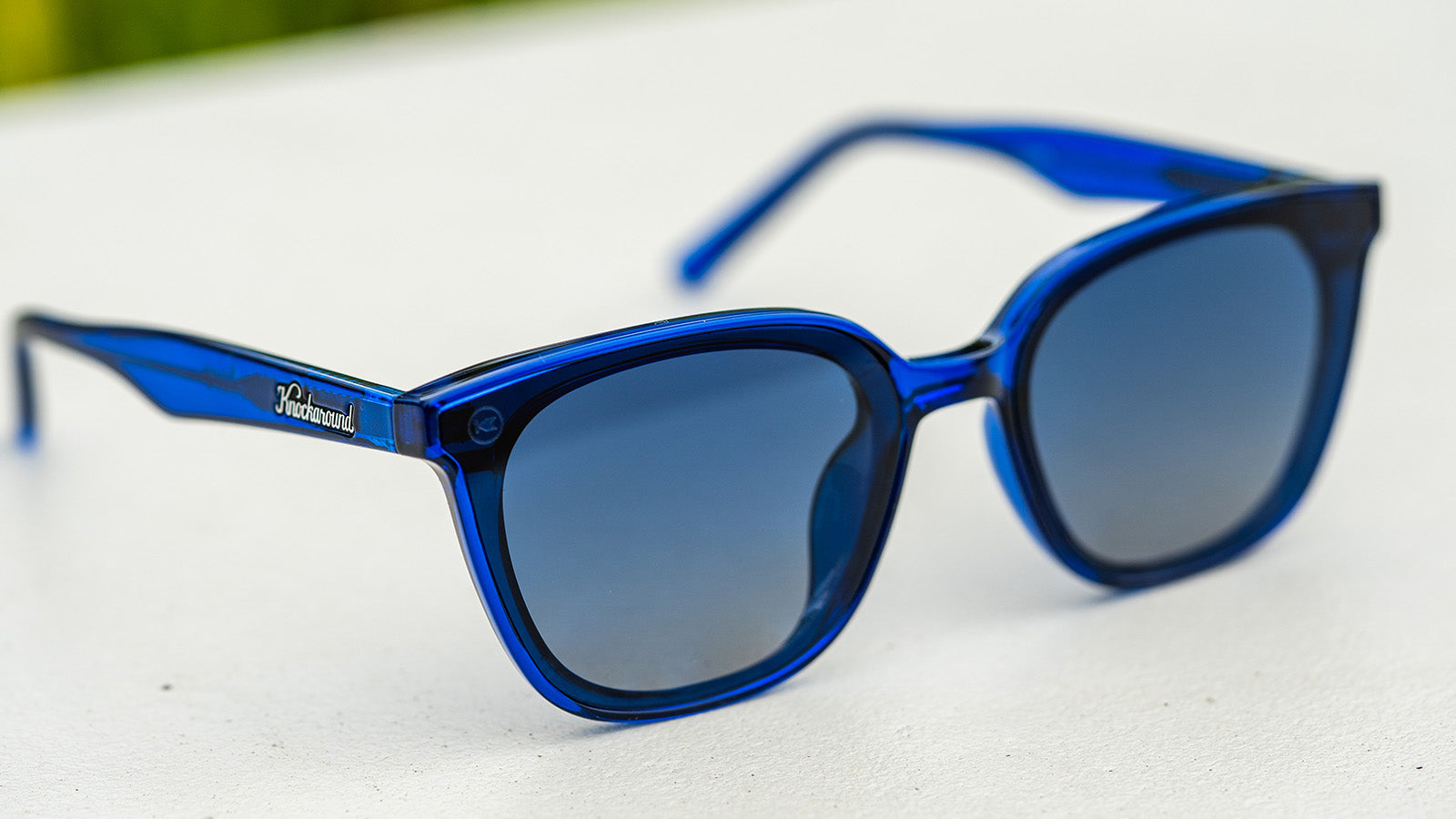 Sunglasses with a blue frame with polarized blue lenses, flyover