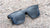 Sunglasses with a black frame with polarized black lenses, flyover