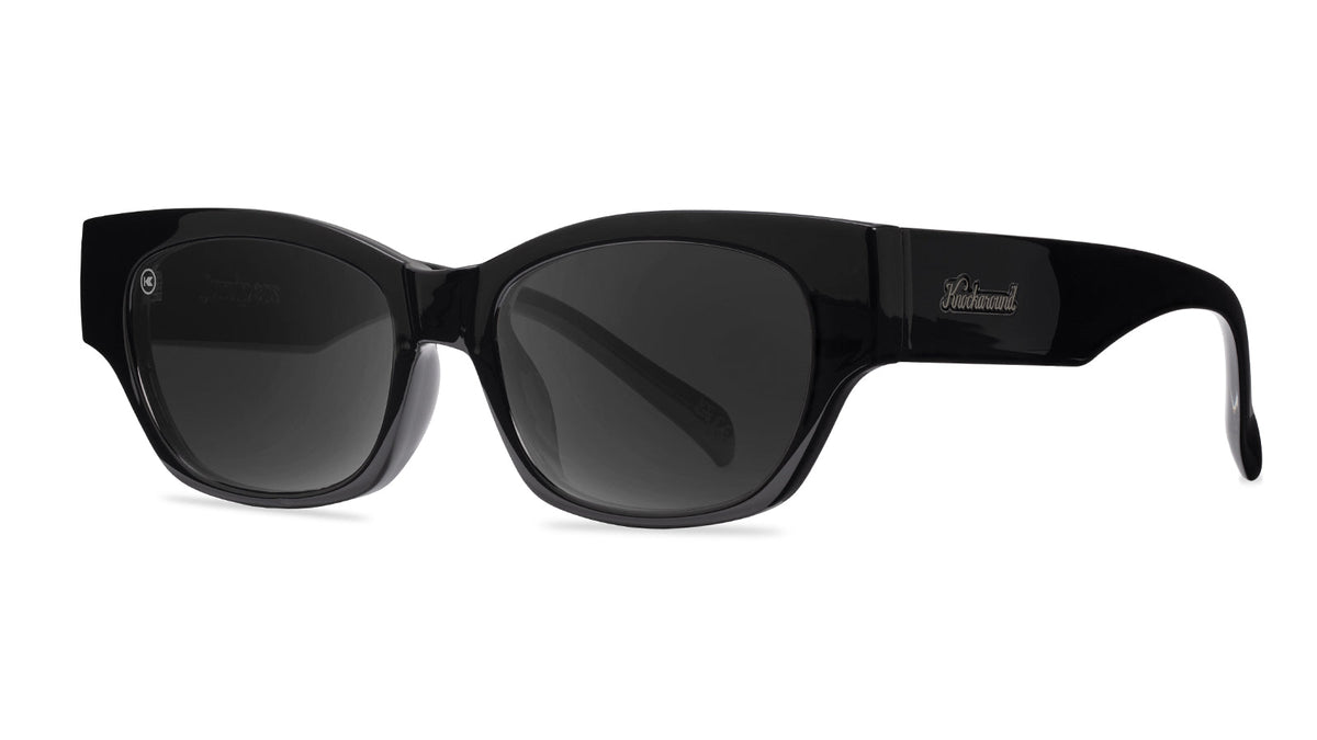 Sunglasses with a glossy black frame and polarized smoke lenses, Threequarter